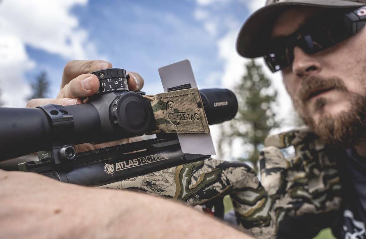 man hunting and turning scope turret